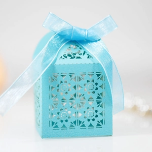 Elegant light blue laser cut hollow gift box with floral pattern and satin ribbon bow