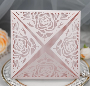 Detailed laser-cut rose pattern on elegant pink wedding invitation card with floral decor