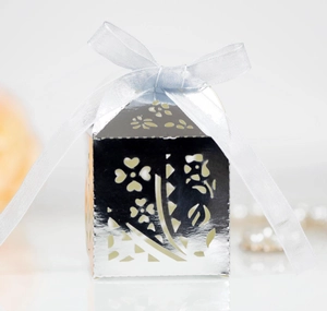 Detailed laser-cut silver candy box with flower patterns and light blue ribbon bow