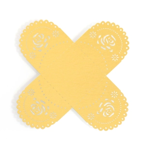 Macro detail of laser-cut paper gift box featuring intricate hollow rose flower patterns