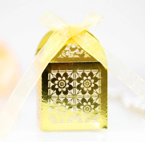 Golden laser-cut gift box with floral patterns and yellow organza ribbon bow