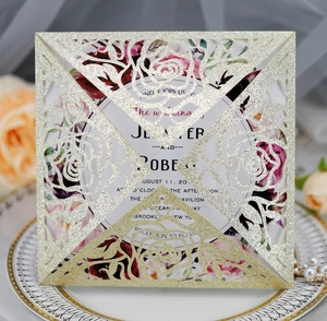 Detailed laser-cut champagne gold glitter wedding invitation with elegant rose pattern