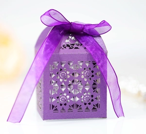 Detailed close-up of a purple laser-cut candy gift box featuring an elegant ribbon bow