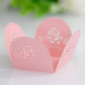 Detailed laser-cut cupcake wrapper in pink paper with elegant rose floral patterns