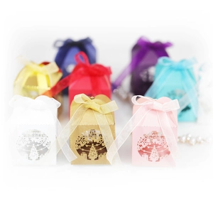 Laser-cut Christmas tree gift boxes in multiple colors with elegant ribbon bows