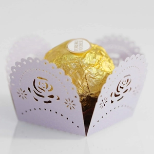 Macro detail of laser-cut lavender paper rose lace wrap for chocolate decoration