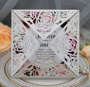Detailed laser-cut rose pattern on elegant pink wedding invitation card with floral insert
