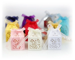 Laser cut floral hollow candy gift boxes with silk ribbons in various elegant colors