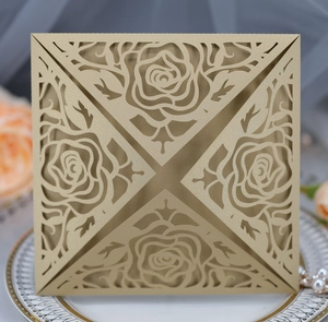 Close-up of champagne laser-cut rose invitation card on elegant pearl setting