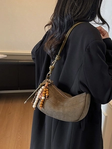 Olive green suede moon crescent shoulder bag with vintage beaded tassel and knot strap