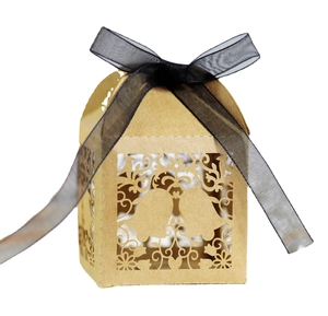 Laser-cut kraft paper gift box with snowflake bell patterns and black organza ribbon bow