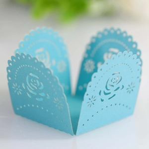Laser-cut light blue paper candy box with intricate rose and star hollow pattern