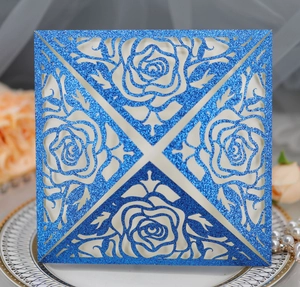 Detail of royal blue glitter laser-cut rose invitation with elegant pearly inner card