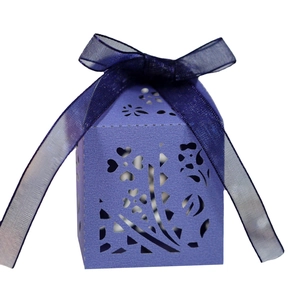 Elegant laser-cut purple candy box with floral patterns and blue organza ribbon bow