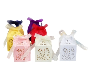 Laser-cut hollow candy gift boxes with floral heart patterns and satin bows in six colors