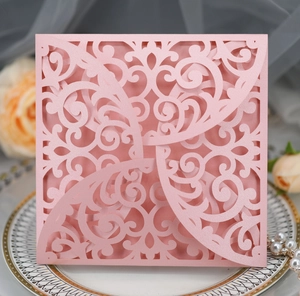 Detailed laser-cut floral pattern on a pink pearlescent paper wedding invitation