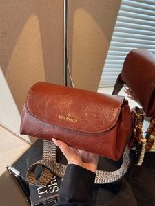 Retro reddish brown crossbody bag with ethnic woven strap and vintage wooden bead charm