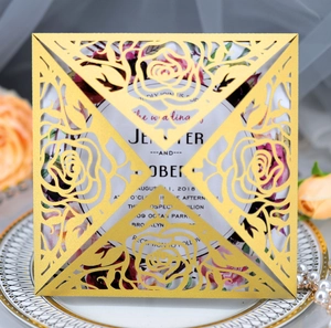 Detail of laser-cut rose hollow wedding invitation with gold pearlescent paper finish