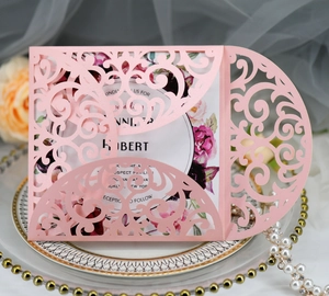 Macro detail of laser-cut rose hollow wedding invitation on decorative porcelain plate