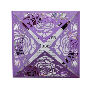 Elegant purple laser-cut wedding invitation featuring a hollow rose pattern with floral insert