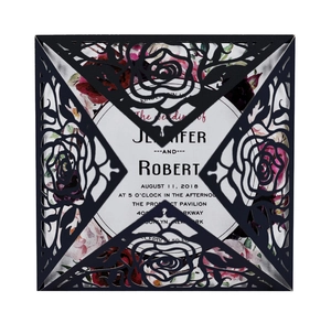 Close-up of laser-cut rose wedding invitation with elegant floral insert and detail