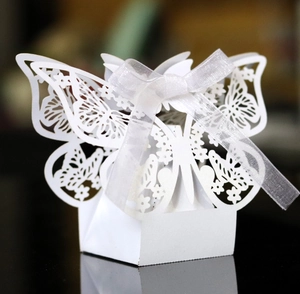 Detailed laser-cut white butterfly candy box with delicate patterns and ribbon bow