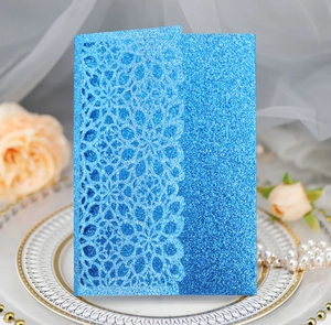 Detailed laser cut lace pattern on blue glitter business and wedding invitation card