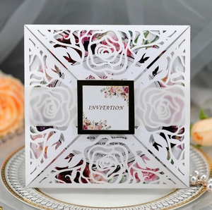 Laser cut rose wedding invitation with white floral shell and elegant belly band cover