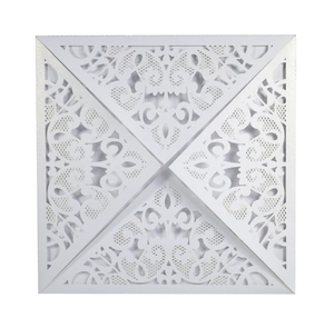 Macro detail of laser-cut floral pattern on white pearlescent square wedding invitations