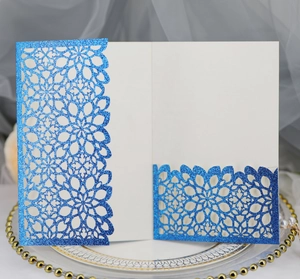 Detail of laser-cut blue glitter wedding invitation with elegant hollowed pattern