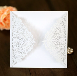 Detailed laser-cut white lace floral design on a square wedding invitation sleeve