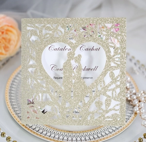 Détail de l'invitation de mariage découpée au laser avec cœur et silhouette pailletée or