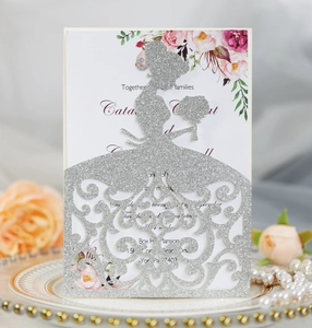 Macro detail of silver glitter laser-cut wedding invitation with elegant bride silhouette