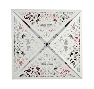 Close-up of laser-cut ivory lace square wedding invitation with elegant floral inner card