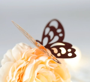 Golden hollow paper butterfly wall sticker on flower petals for home and party decoration