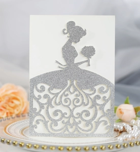 Macro detail of laser-cut wedding invitation featuring silver glitter bride silhouette