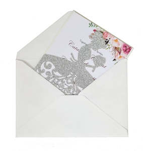 Elegant laser-cut silver glitter wedding invitation set with floral card and white envelope
