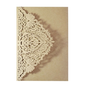 Macro view of laser-cut lace mandala patterns on cream wedding invitation cardstock