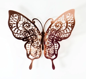 Macro view of rose gold hollow lace butterfly wall sticker with intricate mesh details