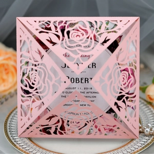 Pink laser-cut rose wedding invitation with floral envelope and elegant white insert card