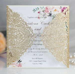 Macro detail of laser cut gold glitter lace invitation with elegant floral insert card