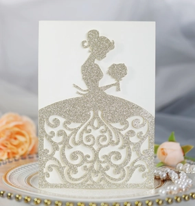 Detailed laser-cut wedding invitation featuring a glittery bride silhouette and floral lace
