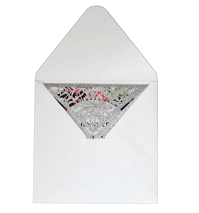 Detail of silver laser-cut hollow lace invitation cover with elegant inner floral card