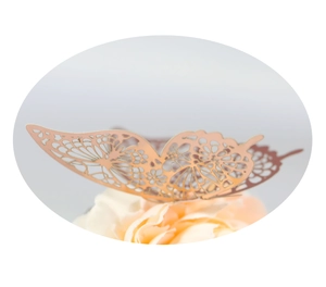 Close-up of rose gold 3D hollow butterfly wall sticker with intricate floral cutout patterns