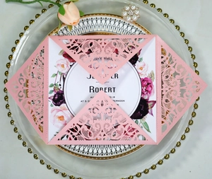 Pink laser-cut lace wedding invitation cards set with elegant floral design and inner sheet