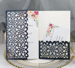 Navy laser-cut glitter wedding invitation with floral insert and RSVP card on elegant tray