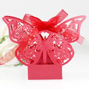 Detail of red laser-cut butterfly candy box with matching organza ribbon and bow
