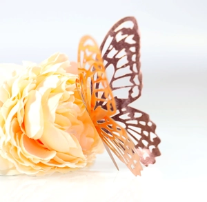 Detailed close-up of 3D hollow butterfly wall sticker in elegant rose gold metallic finish