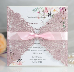 Laser cut glitter wedding invitation with pink ribbon and floral pattern inner card