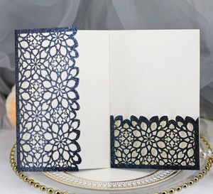 Detail of laser-cut navy blue glitter invitation with elegant mandala lace pattern